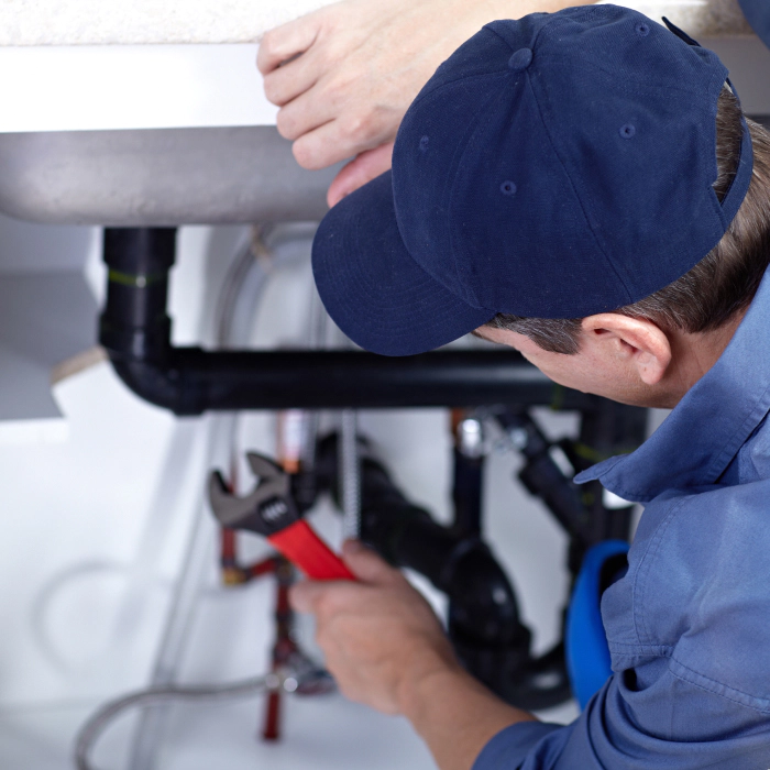 plumber repairing a sink in a kitchen pittsburgh pa